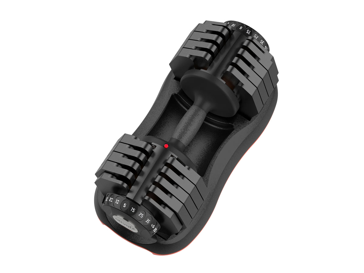 Close-up of adjustable weight dial on black and orange dumbbell for strength exercises