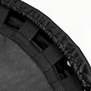 Close-up detail of a black trampoline or exercise mat showing the black mesh surface, padded edge, and webbing straps against a white background.